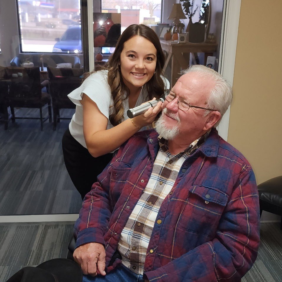 Whitney Justice performing an ear examination for a patient at Sidney Sound & Hearing Services